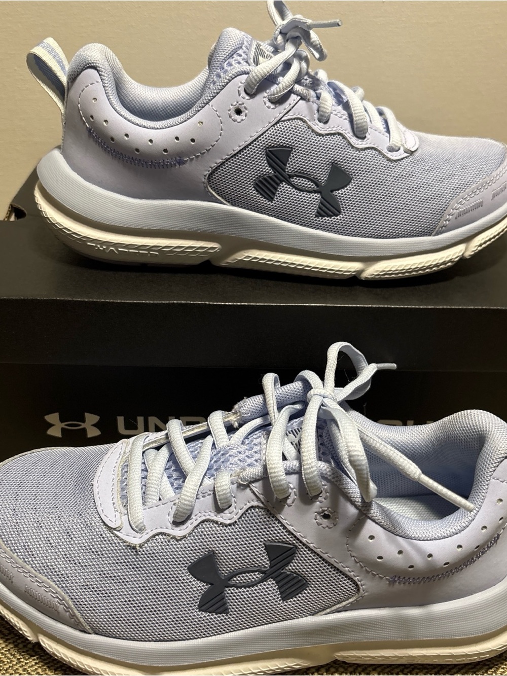 Under Armour women’s Light Lavender and White Sneakers. Charged Assert 10.